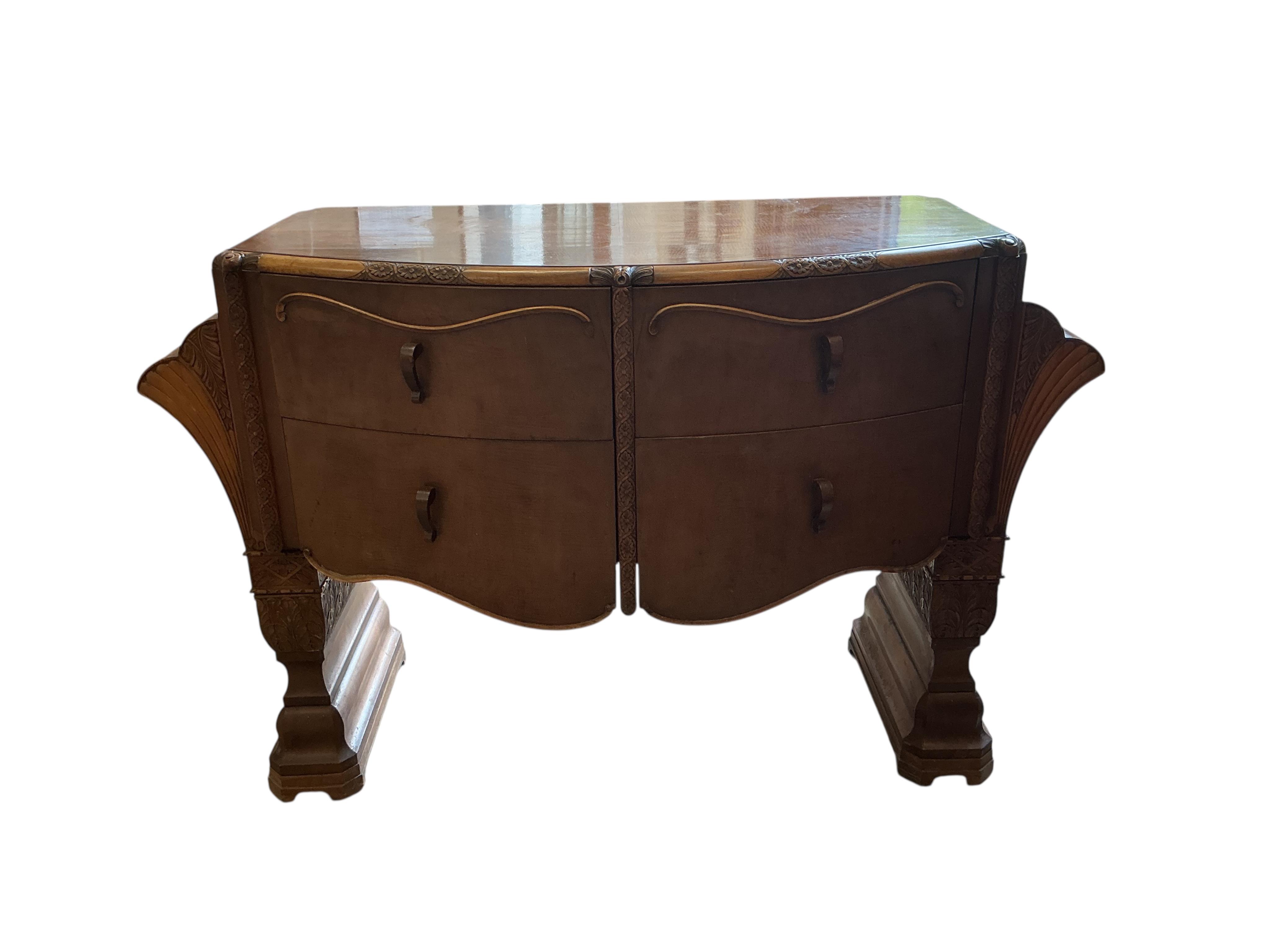 An Art deco walnut dining suite, comprising: dining table, width 190cm, depth 110cm, height 80cm together with eight chairs (two being carvers) and a bow front sideboard